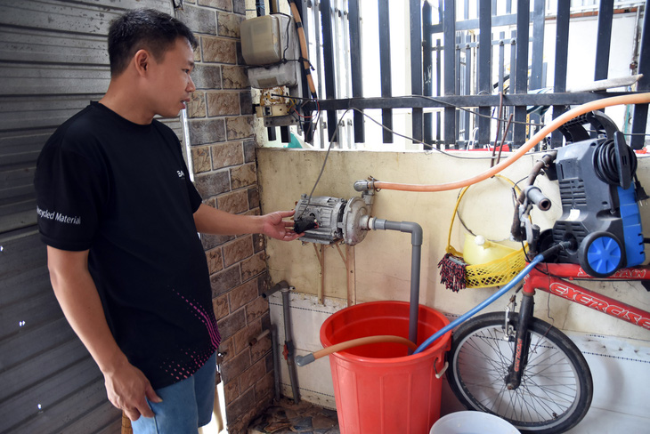 Do nước máy tuột áp, người dân phải bỏ tiền mua thêm máy bơm để tăng bo nước lên bồn chứa trên cao - Ảnh: A LỘC