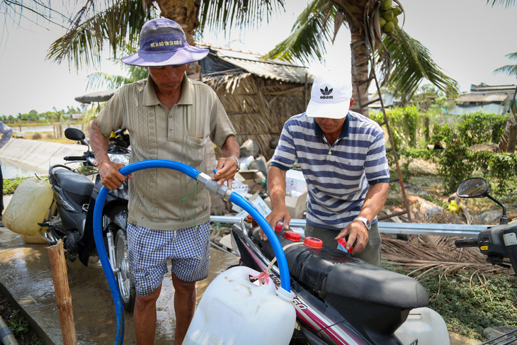 Người dân Tiền Giang lấy nước ngọt sử dụng trong cao điểm xâm nhập mặn tháng 4 - Ảnh: PHƯƠNG QUYÊN