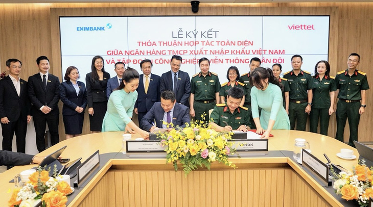 Ông Nguyễn Hoàng Hải- quyền tổng giám đốc Eximbank (bên trái) và ông Nguyễn Mạnh Hổ - đại diện tập đoàn Viettel cùng đại diện lãnh đạo hai đơn vị trong buổi lễ ký kết thỏa thuận hợp tác - Ảnh: Eximbank