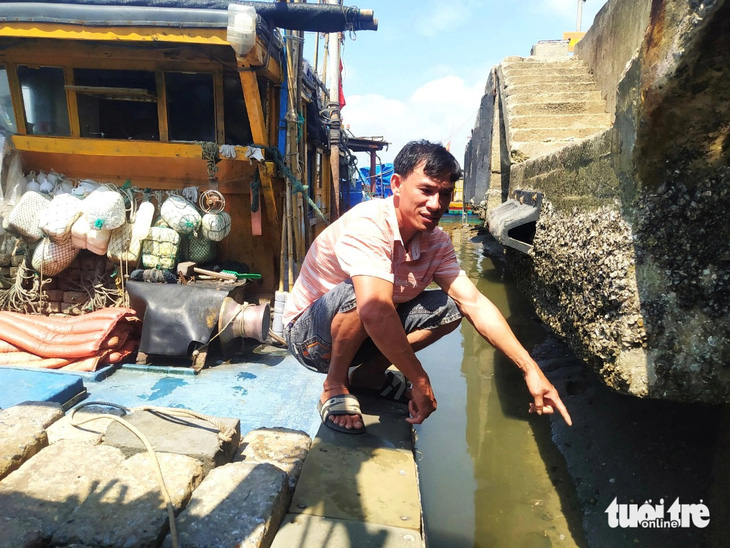 Ngư dân Nguyễn Thanh Tùng than thở luồng lạch bị bồi lắng gây khó khăn khi đưa tàu vào cảng cá Cửa Sót - Ảnh: LÊ MINH