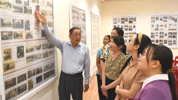 Ông Nguyễn Đại Hùng Lộc thuyết minh cho các bạn trẻ về những tấm bưu ảnh trăm năm tái hiện hành trình Nguyễn Ái Quốc - Ảnh: Tự Trung