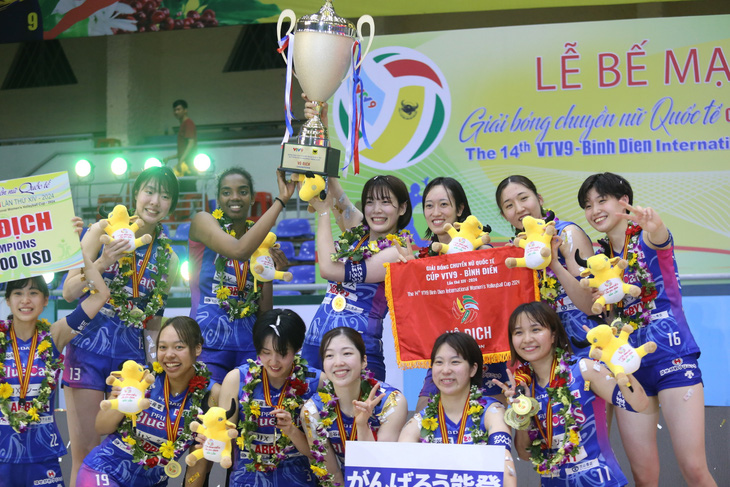 Đội bóng Nhật Bản tươi cười bên cạnh chiếc cúp vô địch - Ảnh: ĐỨC KHUÊ