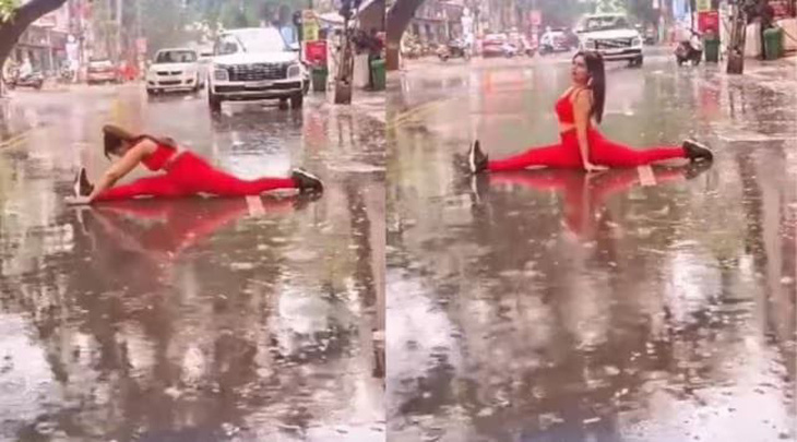 Ảnh cắt từ clip ghi lại cảnh một phụ nữ đang tập yoga giữa đường để quay phim ở thành phố Rajkot, bang Gujarat, Ấn Độ - Ảnh: Indian Express