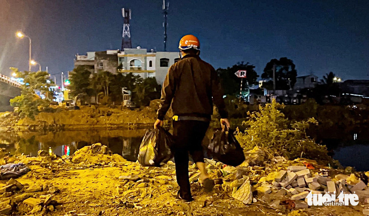 Người dân vứt thẳng rác xuống kênh Tham Lương - Bến Cát (đoạn cầu Trường Đai, quận Gò Vấp) - Ảnh: Nhóm phóng viên