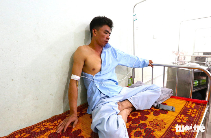 Anh Hoàng Đình Thủy điều trị tại bệnh viện bàng hoàng kể lại vụ sạt lở - Ảnh: L.M.