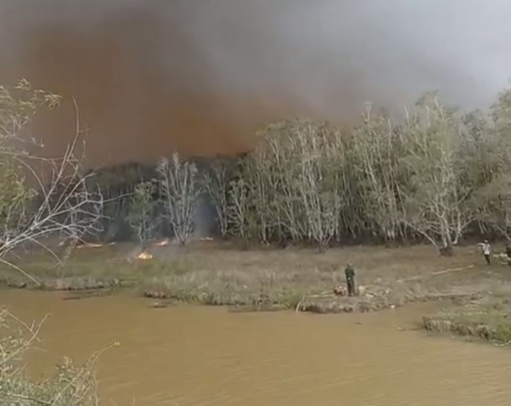 Hàng trăm người gồm nhiều lực lượng đang chữa cháy ở khu vực nằm sâu trong phân khu A1, Vườn quốc gia Tràm Chim - Ảnh: CTV