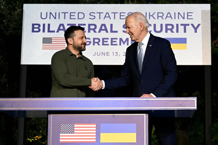 Tổng thống Mỹ Joe Biden (phải) và người đồng cấp Ukraine Volodymyr Zelensky bắt tay sau khi ký thỏa thuận an ninh song phương bên lề Hội nghị thượng đỉnh G7 ở Ý hôm 13-6 - Ảnh: AFP