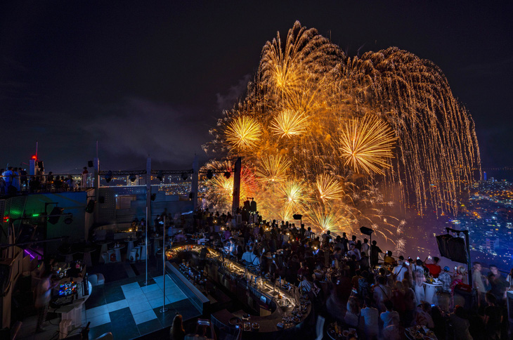 Khách ngắm pháo hoa từ trên sân thượng một tòa nhà ở Đà Nẵng - Ảnh: T.NGHĨA