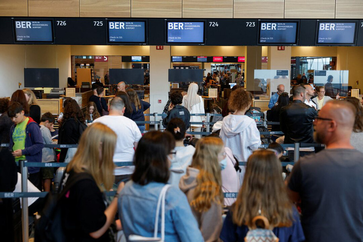 Hành khách tại một sân bay gần Berlin (Đức) - Ảnh: REUTERS