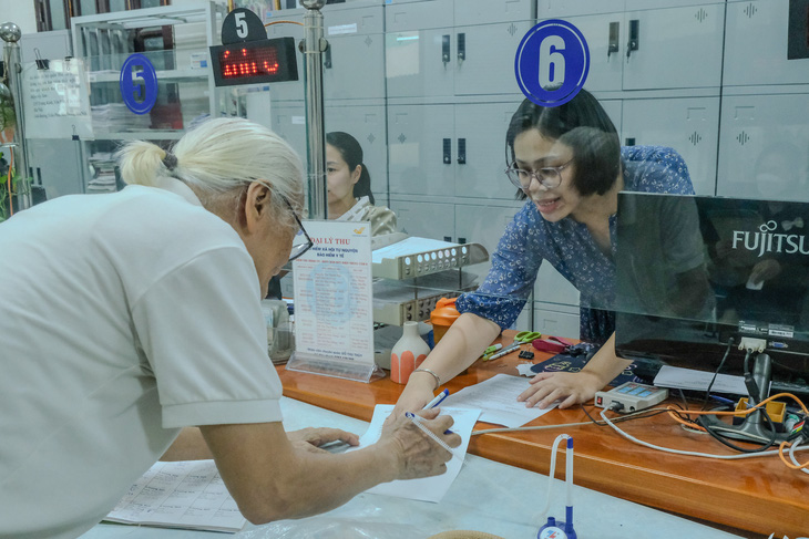 Người dân làm thủ tục tại Bảo hiểm xã hội quận Hai Bà Trưng, Hà Nội - Ảnh: HÀ QUÂN