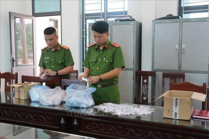 Công an thị xã Thái Hòa kiểm tra tang vật vụ án - Ảnh: TTXVN 