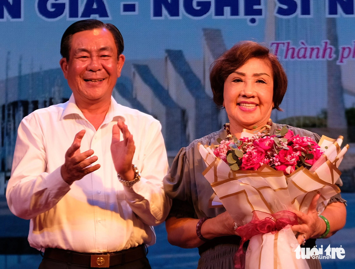 Phó chủ tịch UBND tỉnh Trà Vinh Lê Thanh Bình (trái), trưởng ban vận động xây dựng khu lưu niệm soạn giả Viễn Châu, tặng hoa cho nghệ sĩ Lệ Thủy sáng 8-6 - Ảnh: LINH ĐOAN