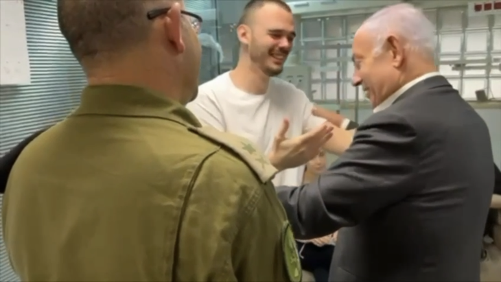 Ảnh chụp màn hình video cho thấy con tin vừa được giải thoát Andrey Kozlov hạnh phúc ôm chầm lấy Thủ tướng Israel Benjamin Netanyahu