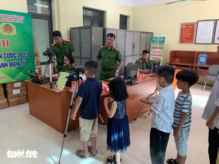 Nhiều trẻ em ở Hà Nội được phụ huynh đưa đến trụ sở công an để làm thẻ căn cước từ sớm - Ảnh: ANH TẤN
