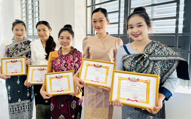 Các lưu học sinh Lào nhận bằng khen của Đại sứ quán Lào tại Việt Nam - Ảnh: M.G.