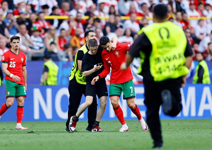 Các cổ động viên lao vào sân tiếp cận Ronaldo (số 7) khiến trận đấu bị gián đoạn - Ảnh: REUTERS