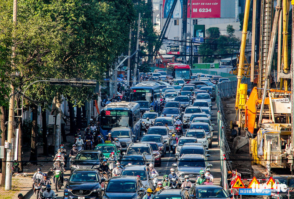 Hàng trăm ôtô, xe máy chôn chân do bắt đầu cấm xe lên cầu vượt Nguyễn Hữu Cảnh - Ảnh 2.