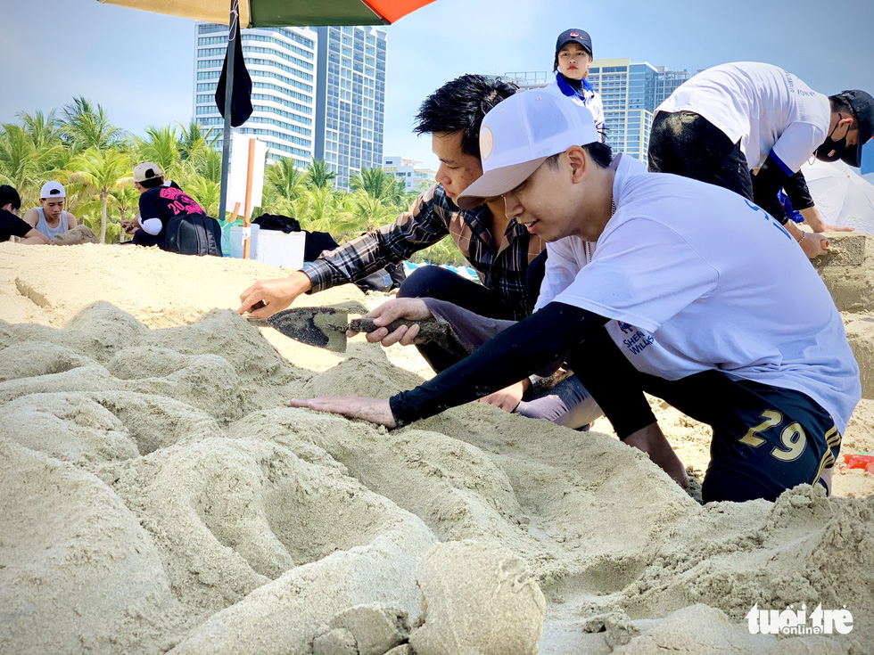 Bạn trẻ truyền thông điệp bằng tượng cát trên bãi biển Đà Nẵng - Ảnh 1.