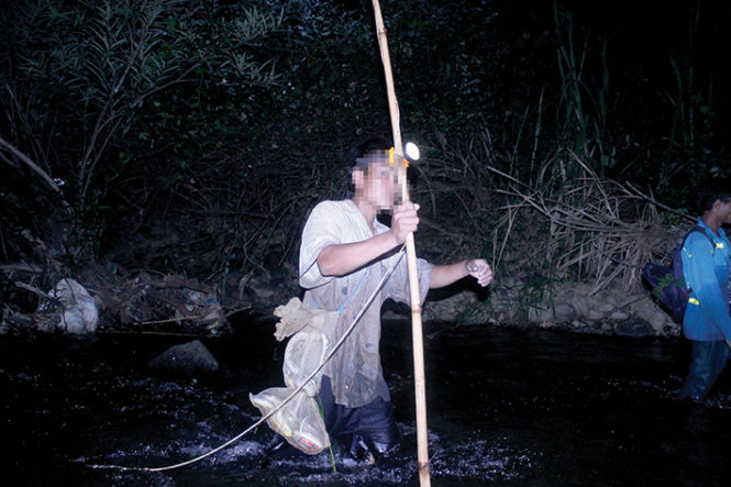 Nhóm đi săn lội suối suốt đêm tìm rắn và nhiều loại thú rừng khác. -Ảnh: M.VINH