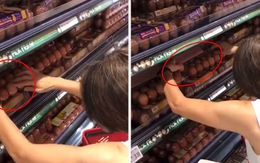 Người phụ nữ tranh thủ lựa trứng gà ngon đã đóng hộp trong siêu thị