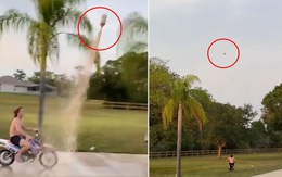 Chàng trai chạy xe máy bắt gọn chai nước bay trên không