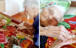 Con trai tóc bạc trắng ngồi bóc nhãn cho mẹ già 109 tuổi ăn