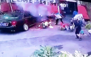 Video: Người đàn ông kéo chiếc xe máy đang bốc cháy ra khỏi khu vực đậu xe ôtô