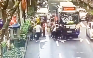 Video: Hàng chục người hợp sức cứu cô gái bị xe buýt cuốn vào gầm