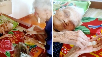 Con trai tóc bạc trắng ngồi bóc nhãn cho mẹ già 109 tuổi ăn