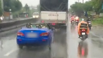Lexus mui trần đội mưa chạy trên đường