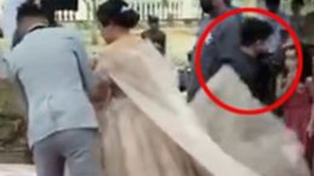 Chàng trai lồm cồm bò ra từ trong váy cô dâu giữa hôn lễ