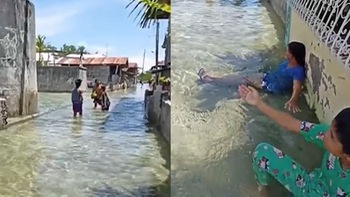 Nước thủy triều trong vắt, người dân Philippines đổ ra đường tắm